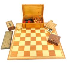 A 20thC chess board, together with a treen box containing various chess pieces, the board 50cm x 50c