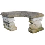 A composition garden bench, the top of fan form raised on two dolphin carved supports, 44cm high, 10