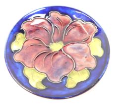 A Moorcroft pottery dish, decorated in the Clematis pattern, impressed marks, 11.5cm diameter.