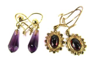 Two pair of drop earrings, comprising a pair of 9ct gold drop suns, and a pair of amethyst 9ct gold