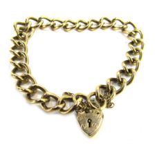 A 9ct gold curb link bracelet, with safety chain and heart shaped padlock, 20cm long, 20g all in.