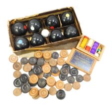 A Banda carpet bowls set, boxed, together with various turned boxwood draughts counters, and a boxed