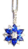 An 18ct white gold, sapphire and diamond pendant and chain, the star design pendant, with three marq