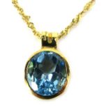 A blue zircon circular pendant and chain, set in a rubbed and moulded mount, stamped 750, 2cm high,