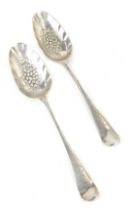 A near pair of George II silver berry spoons, maker EC and CC, London 1742 and 1744, 3.67oz. (2)