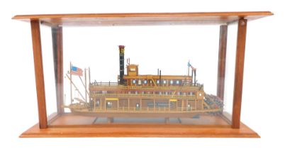 A scratch built model of a steamer boat, titled The King of Mississippi, 62cm wide, contained in a g