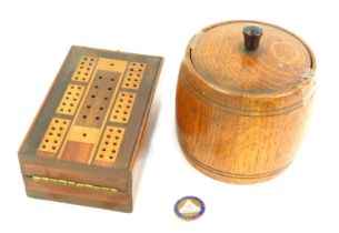 An early 20thC oak tea caddy, 14cm high, and a boxwood draughts board, 13cm wide, together with a Ho