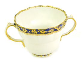 A late 18thC Derby twin ecuelle, of fluted ogee form, decorated in cobalt blue and gilt, with a band