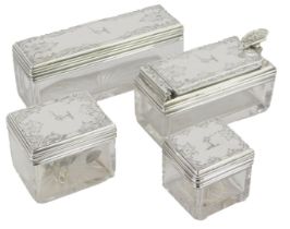 A set of four silver and cut glass dressing table jars, each of rectangular form, with floral scroll