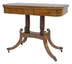 A Regency mahogany and brass inlaid tea table, the rounded top with scrolling brass inlay, on two sp