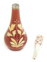 An early 20thC milk glass bud vase, painted with flowers against a red ground, with silver collar, t