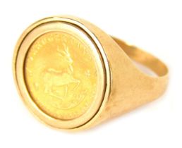 A 9ct gold 1/10th of a krugerrand ring, set with a 1982 1/10 of a krugerrand coin, in a clip setting