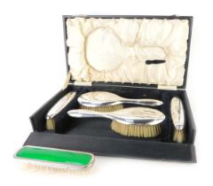 A George V silver four piece dressing table set, of plain design bearing the initials CG, comprising