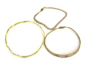 A low grade gold curb link bracelet, marked 333, 4g, a 9ct three colour gold tapered bracelet, impor