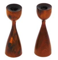 A pair of yew wood candle stands, each on out swept base, 18cm high.