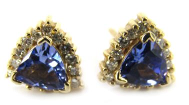 A pair of tanzanite and diamond triangle cut stud earrings, each with single pin back with butterfly