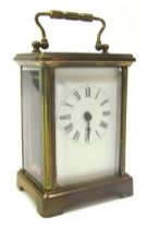 An early 20thC brass cased carriage clock, the rectangular white enamel dial bearing Roman numerals,