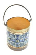 A Doulton Lambeth pottery biscuit barrel, lacking lid, decorated in relief with flowers against a mo