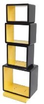 A late 20thC open shelving unit, comprising an arrangement of four recesses in yellow and black meta