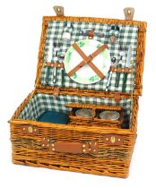 A wicker picnic hamper, with a green and cream chequer lined interior, fitted with cutlery and fitme