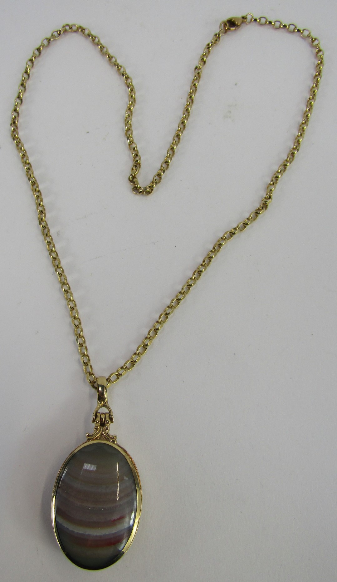 A Victorian semi precious stone set locket and chain, the oval locket set with black agate and strip - Image 2 of 3