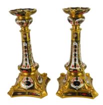 A pair of Royal Crown Derby Old Imari porcelain candlesticks, gold ground, pattern 1128,
