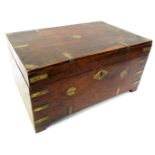 A hardwood and brass bound sewing box, of primitive design, the hinged lid enclosing various recesse