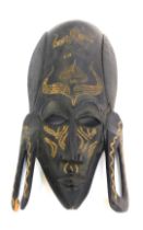 An African ebonised tribal mask, of a gentleman with elongated forehead and ear lobes, 39cm high. (A