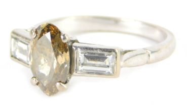 An 18ct white gold diamond dress ring, the oval cut central fancy cut yellow diamond, 9.2mm x 6mm x