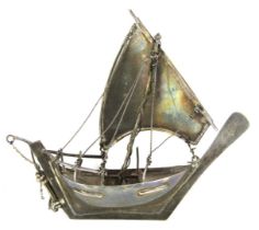 A model of a dhow, white metal, rigged in full sail with moveable rudder, stamped 925, 13cm high, 14
