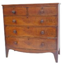 A Victorian mahogany and flame mahogany bow front chest, of two short and three long drawers, on tap