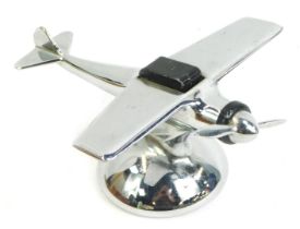 A 1950s American novelty chrome table lighter, modelled as a single propeller aeroplane, 7.5cm high.