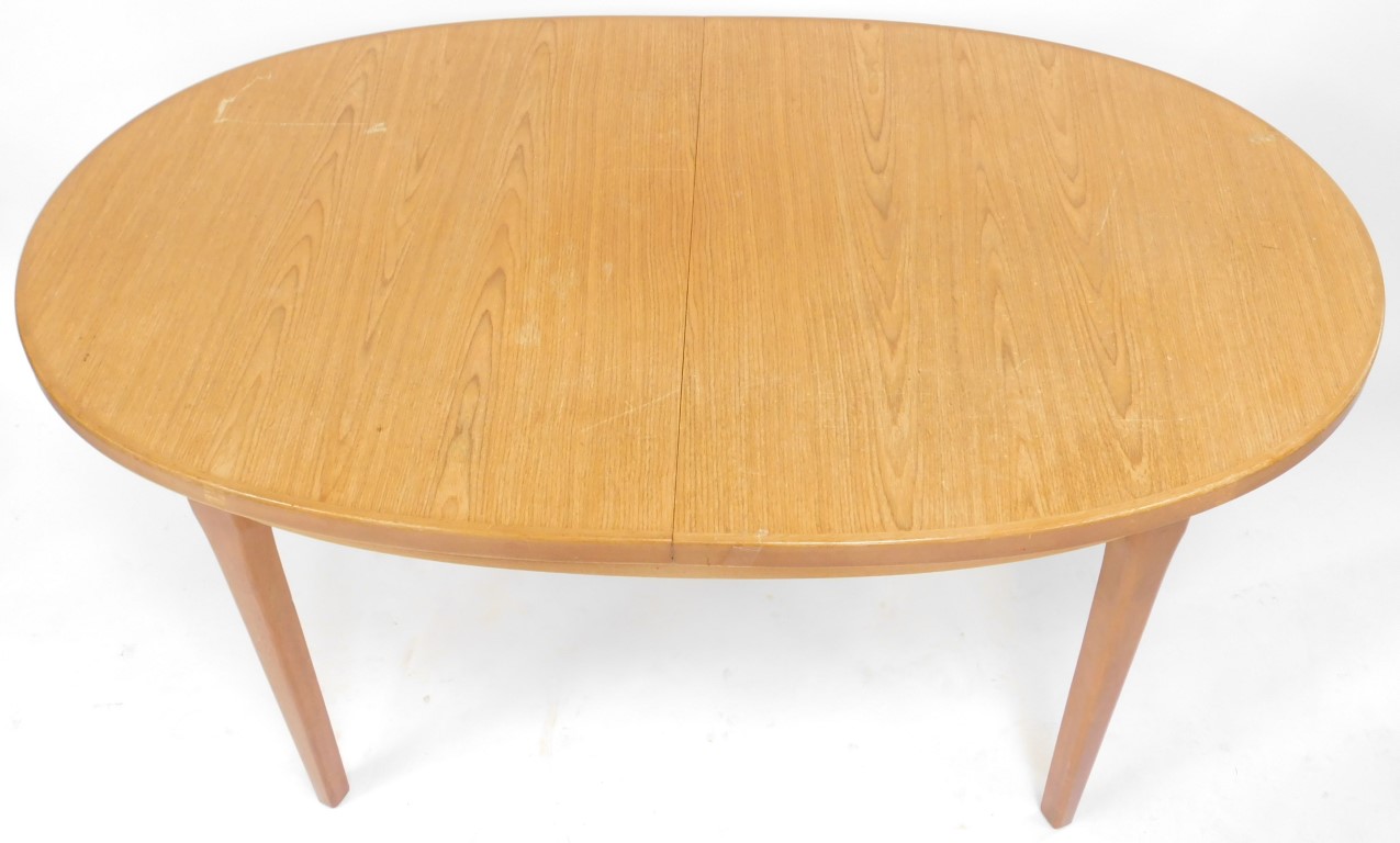 A mid century teak extending dining table, the oval top raised on square tapering legs, 74cm high, t - Image 2 of 5