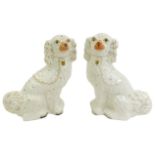 A pair of late 19thC Staffordshire Spaniels, with gilt markings, 33cm high.