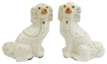 A pair of late 19thC Staffordshire Spaniels, with gilt markings, 33cm high.