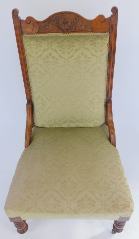 A late 19th/early 20thC walnut framed nursing chair, the floral carved back above an overstuffed gre - Image 2 of 2