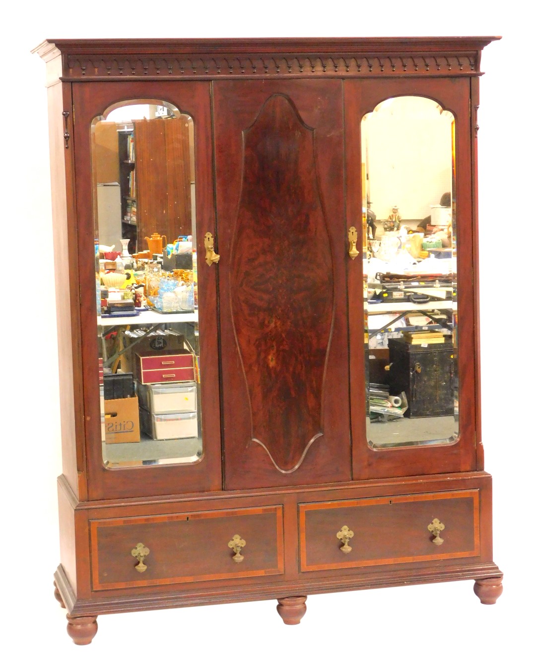 An Edwardian mahogany and flamed mahogany wardrobe, the top with a moulded cornice above a lappet bo