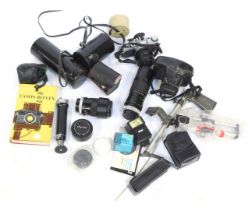 A group of camera equipment, comprising Vivitar automatic extension tube, a Canon AE1 camera, Canon