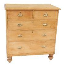 A late Victorian pine chest, the top with a moulded edge above two short and three long drawers, on