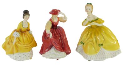 Three Royal Doulton porcelain figures, modelled as The Last Waltz HN2315, Coralie HN2307, Buttercup