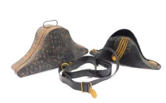 An early 19thC British officer's bicorn hat, contained in a metal case, together with officer's leat