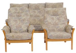 An Ercol Saville light elm framed three piece suite, comprising three seater sofa and two armchairs,