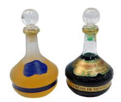 A Herman Jansen bottle of Holland mint liqueur, and another for Creme de Menthe liqueur.