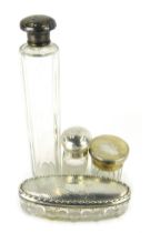 Four cut glass and silver topped jars, comprising an oval dressing table jar, 12cm wide, scent bottl