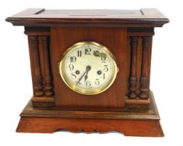A mid 20thC stained mahogany and pine cased mantel clock, the silvered dial bearing Arabic numerals,