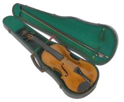 A late 19thC violin, bearing written label dated 1882, two piece back, with bow, cased, the case 78c