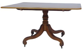 A mahogany and rosewood cross banded dining table, the rectangular top with a rounded edge, on a tur