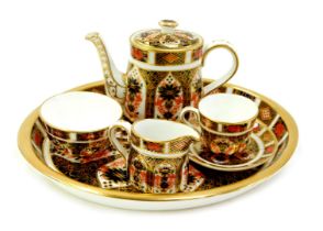 A Royal Crown Derby porcelain Old Imari pattern miniature tea service, pattern 1128, comprising oval