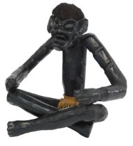 A 20thC carved hardwood figure, of an African gentleman in cross legged seated position, wearing rop