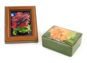 A Moorcroft pottery trinket dish and cover, of rectangular form, decorated in the Green Hibiscus pat